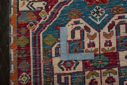 Backside of handmade 2000s Shiraz rug showing knot structure and weave density