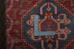 Backside of handmade 2000s Shiraz rug showing knot structure and weave density