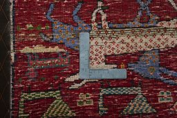 Backside of handmade 2000s Shiraz rug showing knot structure and weave density