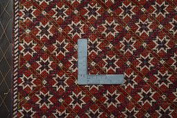 Backside of handmade 2000s Shiraz rug showing knot structure and weave density