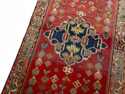 Backside of handmade 2000s Shiraz rug showing knot structure and weave density