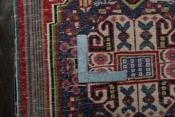Backside of handmade 2000s Shiraz rug showing knot structure and weave density