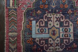 Backside of handmade 2000s Shiraz rug showing knot structure and weave density