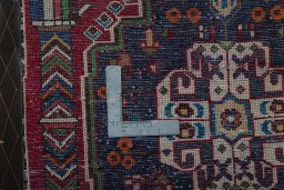 Backside of handmade 2000s Shiraz rug showing knot structure and weave density