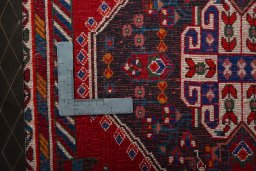 Backside of handmade 1970s Shiraz rug showing knot structure and weave density