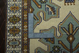 Corner detail of 2000s Torkaman rug showing border pattern and Wool pile