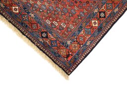 Backside of handmade 1990s Yalameh rug showing knot structure and weave density