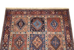 Surface texture of 1990s Yalameh rug with natural Wool and intricate pattern