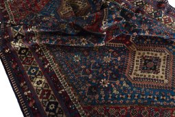 Corner detail of 1970s Yalameh rug showing border pattern and Wool pile