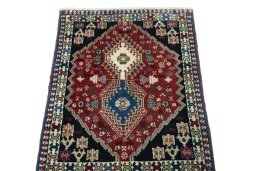 Surface texture of 2000s Yalameh rug with natural Wool and intricate pattern