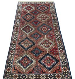 Surface texture of 2000s Yalameh rug with natural Wool and intricate pattern