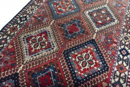 Backside of handmade 2000s Yalameh rug showing knot structure and weave density