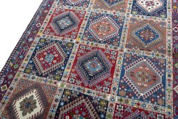 Backside of handmade 2000s Yalameh rug showing knot structure and weave density