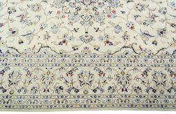 Corner detail of 2000s Kashan rug showing border pattern and Wool pile