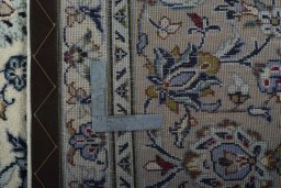 Backside of handmade 2000s Kashan rug showing knot structure and weave density