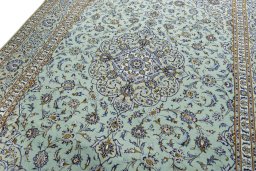 Backside of handmade 2000s Kashan rug showing knot structure and weave density