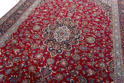 Backside of handmade 2000s Kashan rug showing knot structure and weave density