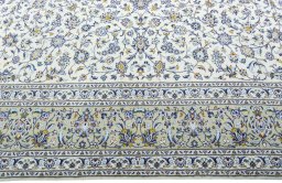 Corner detail of 2000s Kashan rug showing border pattern and Wool pile