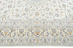 Corner detail of 2000s Kashan rug showing border pattern and Wool pile