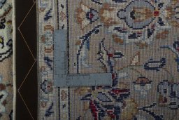 Backside of handmade 2000s Kashan rug showing knot structure and weave density