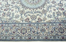 Corner detail of 2000s Nain rug showing border pattern and Wool pile