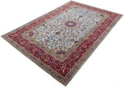 Corner detail of 2000s Kashan rug showing border pattern and Wool pile