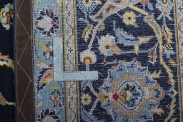 Backside of handmade 2000s Kashan rug showing knot structure and weave density
