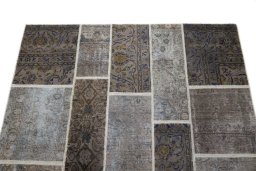 Surface texture of 1960s Patchwork rug with natural Wool and intricate pattern