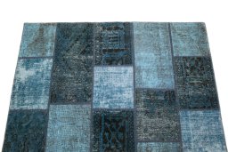 Backside of handmade 1960s Patchwork rug showing knot structure and weave density