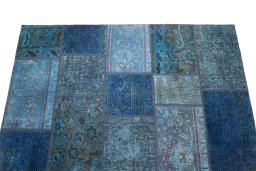 Surface texture of 1960s Patchwork rug with natural Wool and intricate pattern