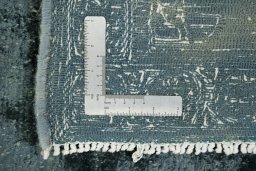 Corner detail of 1940s Vintage rug showing border pattern and Wool pile