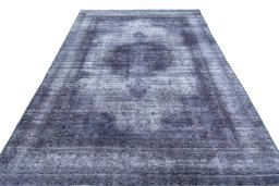 Surface texture of 1970s Vintage rug with natural Wool and intricate pattern