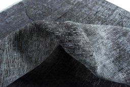 Surface texture of 1970s Vintage rug with natural Wool and intricate pattern