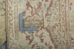 Backside of handmade 1970s Vintage rug showing knot structure and weave density