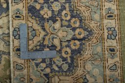 Backside of handmade 1970s Vintage rug showing knot structure and weave density