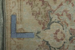 Backside of handmade 1950s Vintage rug showing knot structure and weave density