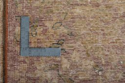 Backside of handmade 1950s Vintage rug showing knot structure and weave density