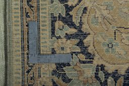 Backside of handmade 1950s Vintage rug showing knot structure and weave density