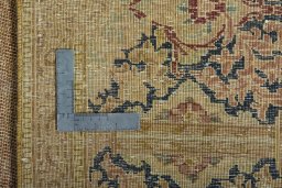 Backside of handmade 1950s Vintage rug showing knot structure and weave density
