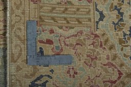 Backside of handmade 1950s Vintage rug showing knot structure and weave density