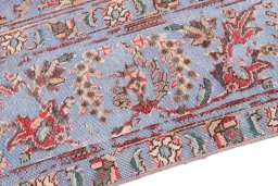 Backside of handmade 1950s Vintage rug showing knot structure and weave density