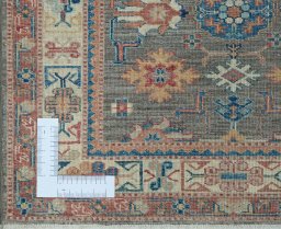 Corner detail of New Kazak rug showing border pattern and Wool pile