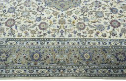 Corner detail of New Kashan rug showing border pattern and Cork pile
