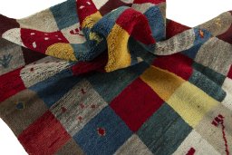 Corner detail of 2000s Persian Gabbeh rug showing border pattern and Wool pile