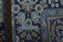 Backside of handmade 2000s Kashan rug showing knot structure and weave density