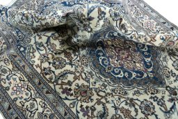 Surface texture of 2000s Nain rug with natural Wool and intricate pattern