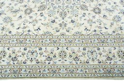 Corner detail of New Kashan rug showing border pattern and Wool pile