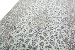 Backside of handmade 2000s Kashan rug showing knot structure and weave density