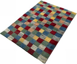 Corner detail of 2000s Persian Gabbeh rug showing border pattern and Wool pile