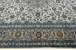 Corner detail of 2000s Kashan rug showing border pattern and Wool pile